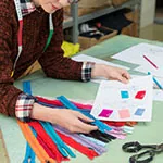design master Designer comparing colour swatches with fabric