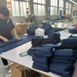 folding-process Workers folding finished textiles