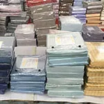 Packed bed linens stacked in the workshop