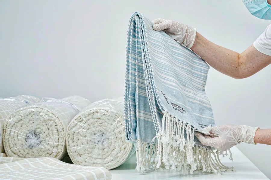 Quality inspection of a striped peshtemal towel before shipment